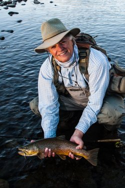 Skip Morris with large brown trout caught on a Morris Minnow; a photograph by ©Carol Ann Morris