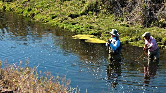 Author Skip Morris and guide GL Britton on Crab Creek fighting a big 'bow