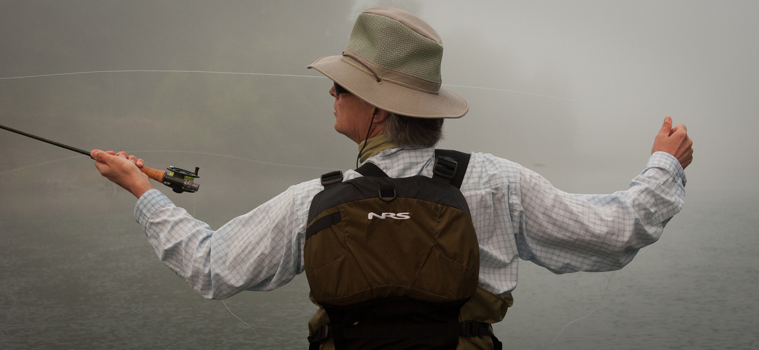 Skip Morris casting in the early morning fog on the river in western Washington state